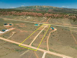 View of rural area with property parcel outlined and a mountain backdrop
