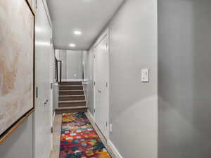 Corridor featuring stairway and recessed lighting