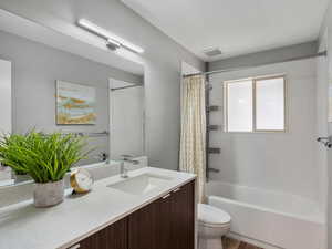 Bathroom with vanity and shower / tub combo with curtain