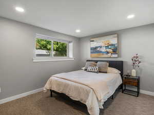 Carpeted bedroom with recessed lighting