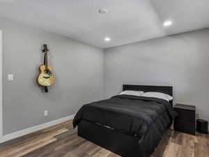 Bedroom featuring wood finished floors and recessed lighting
