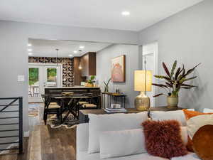 Living room with french doors, dark wood-type flooring, and recessed lighting