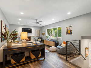 Office area featuring wood-type flooring, a ceiling fan, recessed lighting, and a warm lit fireplace