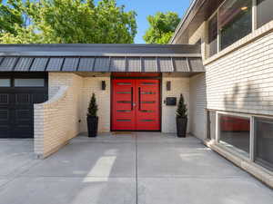 View of exterior entry featuring brick siding