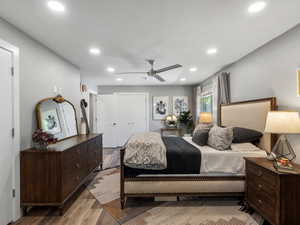 Bedroom featuring wood finished floors, recessed lighting, ceiling fan, and a closet
