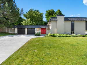 View of front of house featuring brick siding, driveway, and an attached garage