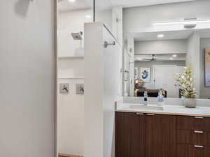 Bathroom featuring ensuite bath, vanity, and ceiling fan
