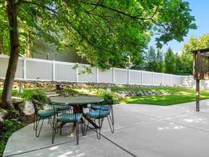 Fenced backyard with outdoor dining area and a patio