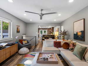 Living area with dark wood finished floors, recessed lighting, and a ceiling fan