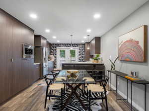 Dining space featuring french doors, light wood-style flooring, and recessed lighting