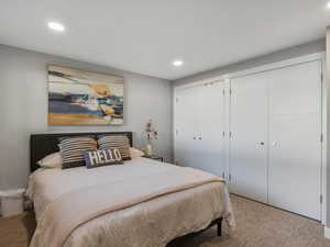 Carpeted bedroom with recessed lighting