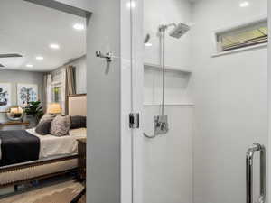 Ensuite bathroom featuring recessed lighting, a shower, and ceiling fan