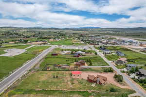 Aerial perspective of suburban area featuring a mountain backdrop and property boundaries highlighted