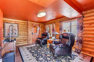 Living room with wood finished floors and rustic walls