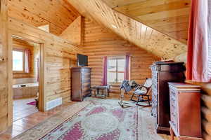 Office area with rustic walls, lofted ceiling, wooden ceiling, and wood finished floors