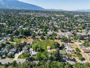 Aerial view of property and surrounding area with nearby suburban area