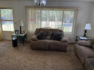 Living room featuring a chandelier and carpet floors