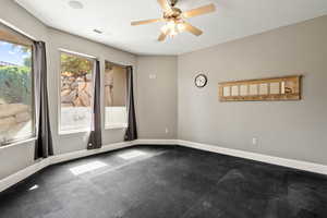 Empty room featuring baseboards and ceiling fan