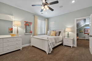 Bedroom with dark colored carpet, recessed lighting, ceiling fan, and vaulted ceiling
