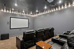 Cinema room featuring carpet floors and recessed lighting