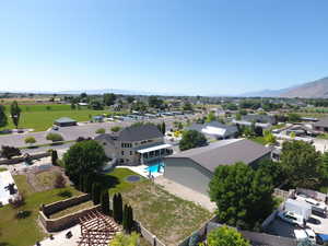 Aerial view of residential area with a mountainous background and a pool area