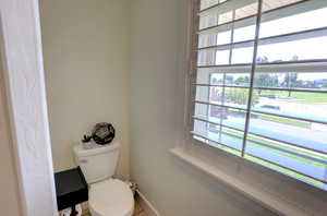 Bathroom with toilet and baseboards