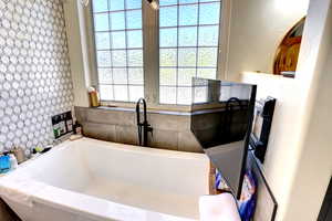 Bathroom featuring a bathtub and plenty of natural light