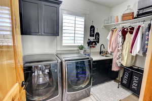Laundry room with cabinet space and washing machine and dryer