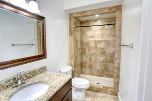 Full bathroom with vanity and a tile shower