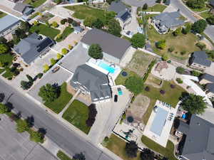 Aerial overview of property's location featuring a pool area and nearby suburban area