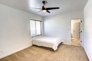 Bedroom with light colored carpet and ceiling fan