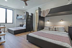 Bedroom featuring wood finished floors, a ceiling fan, and recessed lighting