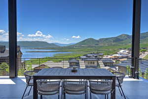 Patio / terrace featuring a water and mountain view