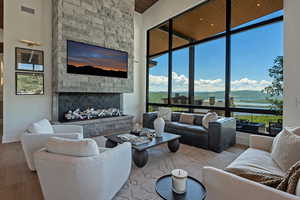 Living area featuring wood finished floors, a fireplace, and floor to ceiling windows
