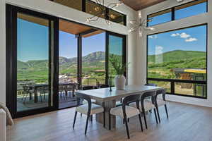 Sunroom / solarium featuring a mountain view and a chandelier