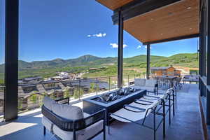 Patio / terrace with an outdoor living space with a fire pit and a mountain view