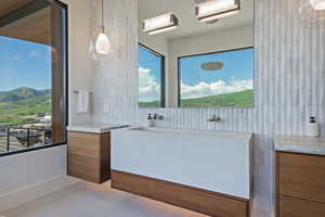 Bathroom with tile patterned floors, vanity, tasteful backsplash, and a mountain view