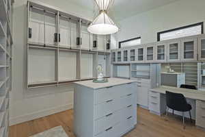 Walk in closet featuring light wood-type flooring