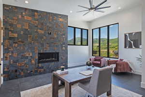 Dining space featuring a ceiling fan, recessed lighting, and a glass covered fireplace