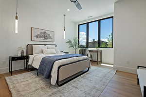 Bedroom with wood finished floors and recessed lighting