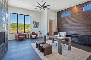 Office space with recessed lighting, tile patterned flooring, a towering ceiling, and a ceiling fan
