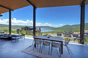 Patio / terrace featuring a water and mountain view and outdoor lounge area