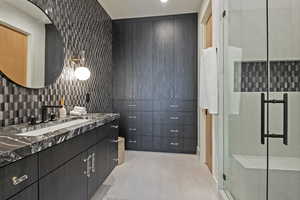 Bathroom with vanity, a shower stall, tasteful backsplash, and wood finished floors