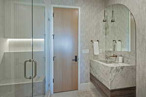 Full bathroom with vanity and a stall shower