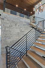 Staircase with wood ceiling, a chandelier, wood finished floors, and recessed lighting