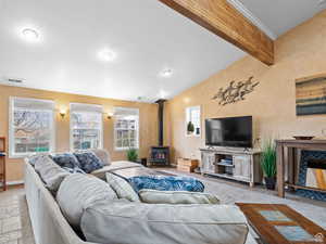 Living area featuring a wood stove and baseboards