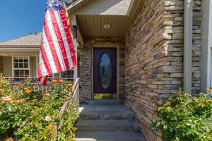 Property entrance featuring stone siding