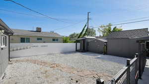 View of yard featuring a storage unit and a patio