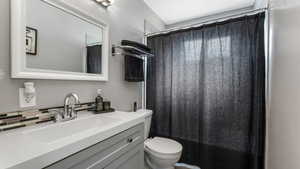 Bathroom featuring vanity and backsplash
