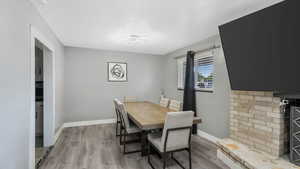 Dining area with wood finished floors and a textured ceiling
